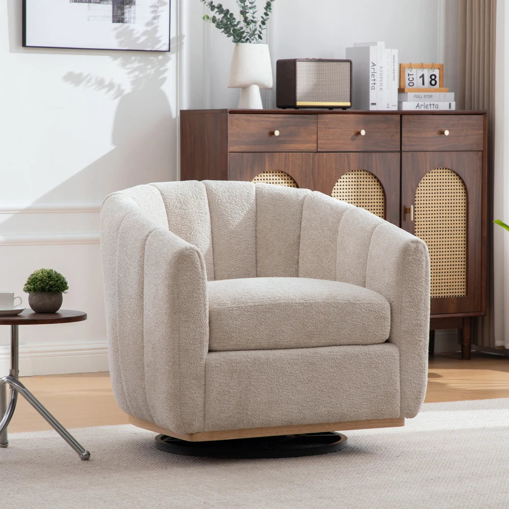 Fauteuil club pivotant en chenille coloris Gris Perle devant un buffet en bois et cannage