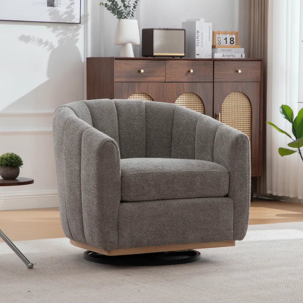 Fauteuil club pivotant en chenille gris ardoise devant un buffet en bois et cannage