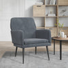 Fauteuil velours gris anthracite près d'une table d'appoint dans un salon