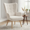 Fauteuil en tissu bouclette blanc capitonné près d'une fenêtre