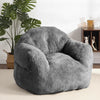 Pouf géant en peluche gris anthracite dans un salon