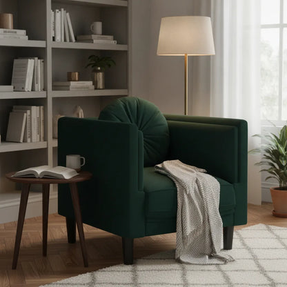 Fauteuil vert foncé avec plaid dans un coin lecture