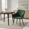 Fauteuil salle à manger velours vert sapin autour d'une table en bois