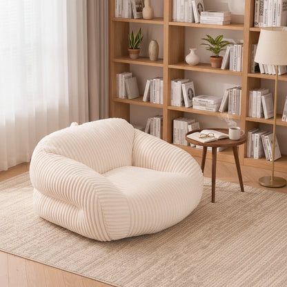 Fauteuil pouf adulte blanc ivoire dans un coin lecture