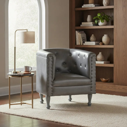 Fauteuil cabriolet cuir Locronan gris capitonné dans un coin lecture