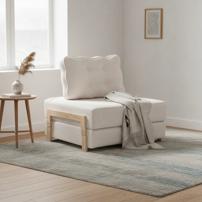 Fauteuil lit pliant Groix beige lin avec plaid dans une chambre