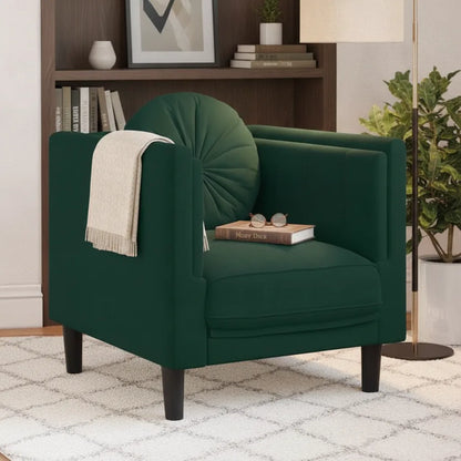 Fauteuil vert foncé en velours devant une bibliothèque
